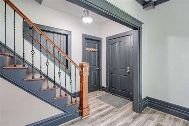 entrance foyer with light wood-type flooring and stairway