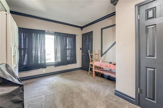 carpeted entrance foyer with ornamental molding and baseboards