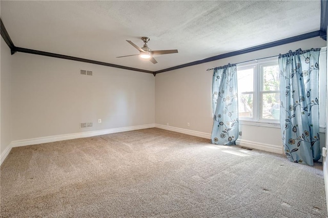 unfurnished room featuring ornamental molding, ceiling fan, baseboards, carpet floors, and a textured ceiling