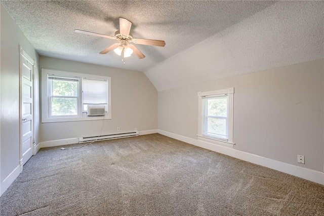 bonus room with a baseboard radiator, plenty of natural light, carpet floors, ceiling fan, and lofted ceiling