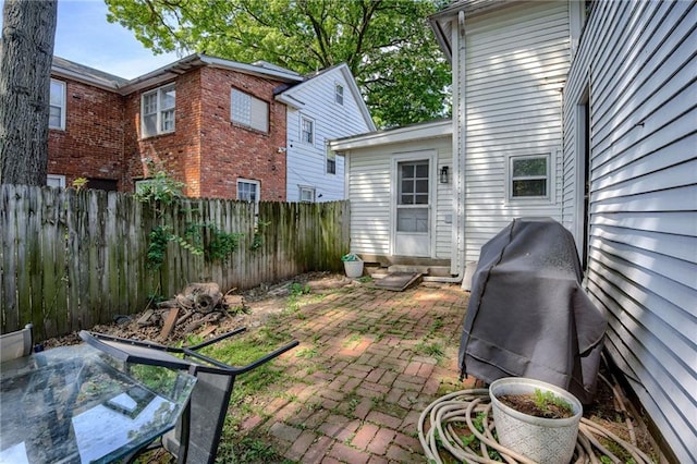 fenced backyard with entry steps and a patio area