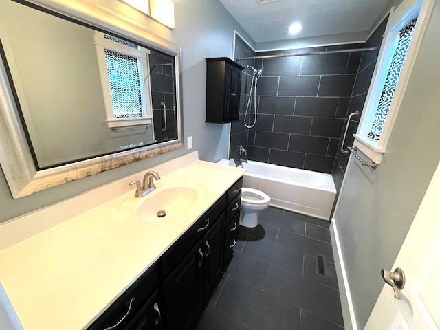 3106 Mill Ct, Pittsburg, KS 66762 - bathroom with toilet, vanity, tile patterned floors, shower / tub combination, and baseboards