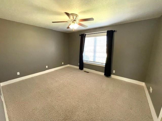 3106 Mill Ct, Pittsburg, KS 66762 - empty room with ceiling fan, light carpet, baseboards, and a textured ceiling