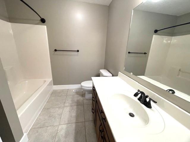 3106 Mill Ct, Pittsburg, KS 66762 - full bathroom featuring tile patterned flooring, toilet, shower / tub combination, baseboards, and vanity