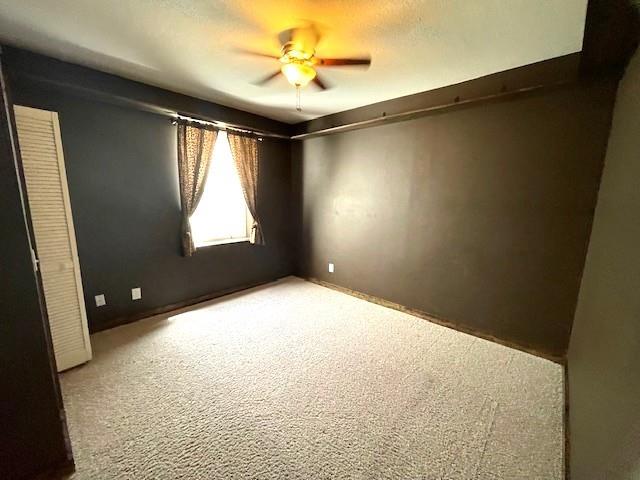 3106 Mill Ct, Pittsburg, KS 66762 - carpeted empty room featuring a ceiling fan
