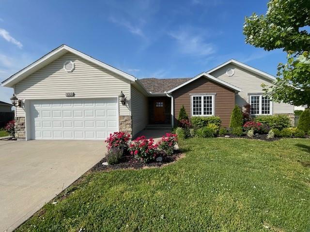 3106 Mill Ct, Pittsburg, KS 66762 - ranch-style home with an attached garage, driveway, stone siding, and a front lawn