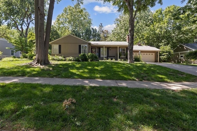 1215 W 69th Ter, Kansas City, MO 64113 - ranch-style home featuring a garage, driveway, a front yard, and a chimney