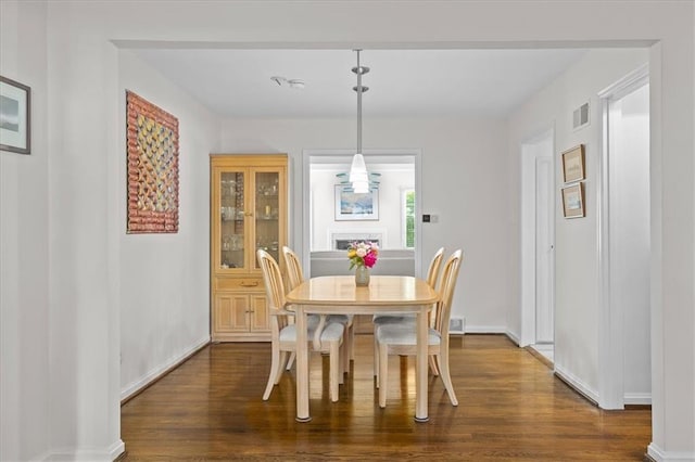 1215 W 69th Ter, Kansas City, MO 64113 - dining area featuring dark wood-type flooring