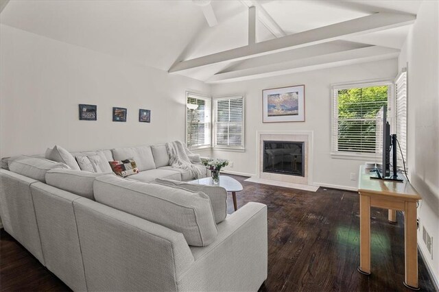 1215 W 69th Ter, Kansas City, MO 64113 - living area featuring dark wood-type flooring, beam ceiling, a tile fireplace, healthy amount of natural light, and high vaulted ceiling