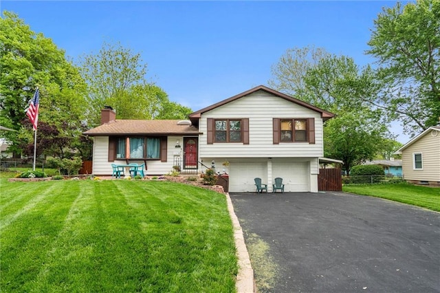 13613 Lowell Ave, Grandview, MO 64030 - split level home featuring an attached garage, a chimney, and driveway