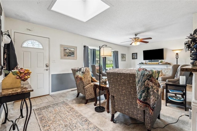 13613 Lowell Ave, Grandview, MO 64030 - living room with a textured ceiling, ceiling fan, and a skylight