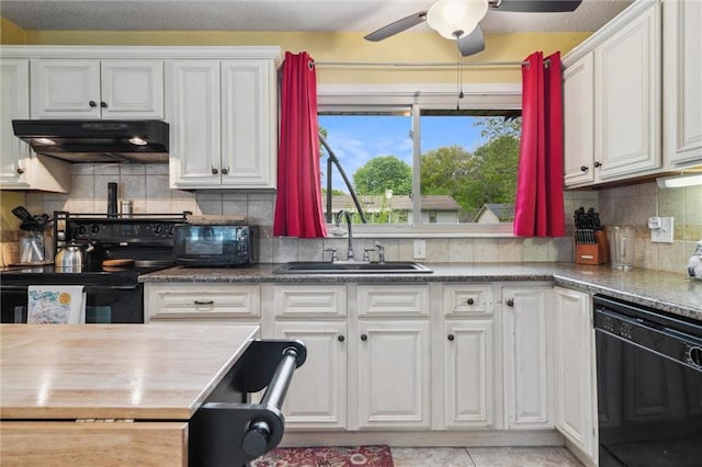 13613 Lowell Ave, Grandview, MO 64030 - kitchen with under cabinet range hood, black appliances, a sink, and white cabinetry