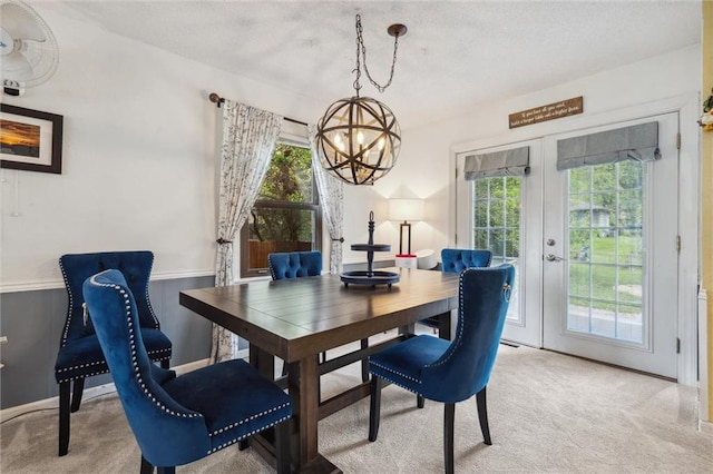 13613 Lowell Ave, Grandview, MO 64030 - dining area with a chandelier, french doors, light carpet, and plenty of natural light