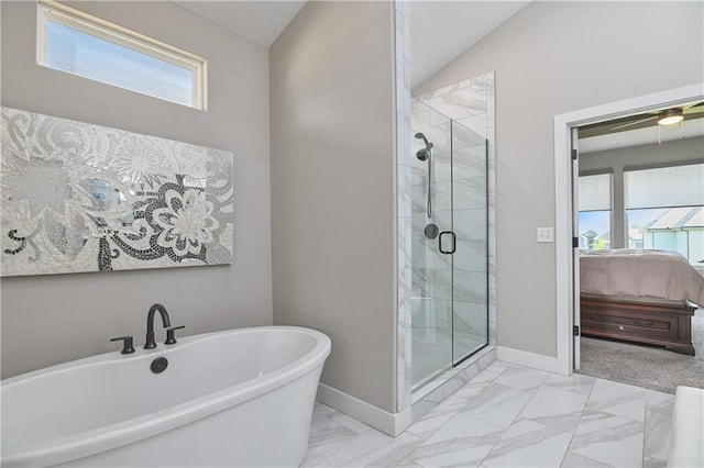 ensuite bathroom with marble finish floor, connected bathroom, a healthy amount of sunlight, and a shower stall