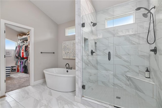 full bath featuring a freestanding tub, a shower stall, and a wealth of natural light