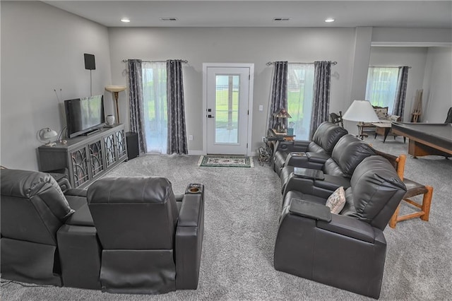 living area featuring a healthy amount of sunlight, carpet, and visible vents