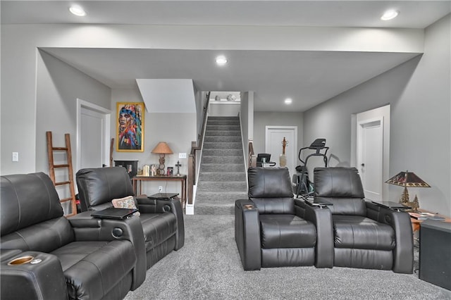 living room featuring carpet flooring, recessed lighting, and stairway