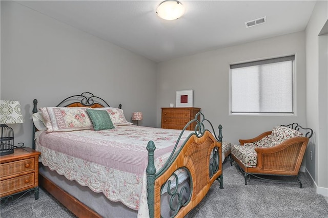 carpeted bedroom featuring visible vents