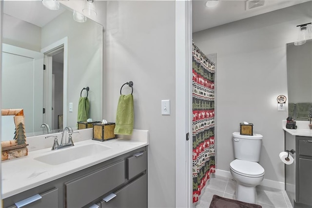 bathroom featuring visible vents, tile patterned flooring, vanity, baseboards, and toilet