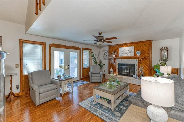 24545 W 54th St, Shawnee, KS 66226 - living room with a ceiling fan, a tiled fireplace, wood finished floors, baseboards, and french doors