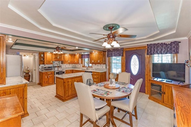 24545 W 54th St, Shawnee, KS 66226 - dining space with a tray ceiling, a ceiling fan, plenty of natural light, and light tile patterned floors