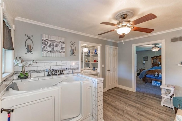 24545 W 54th St, Shawnee, KS 66226 - laundry area featuring a ceiling fan, light wood finished floors, ornamental molding, and baseboards
