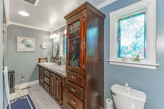 24545 W 54th St, Shawnee, KS 66226 - bathroom featuring ornamental molding, toilet, healthy amount of natural light, double vanity, and baseboards