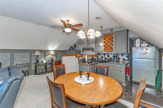 24545 W 54th St, Shawnee, KS 66226 - dining space featuring lofted ceiling, a ceiling fan, and a textured ceiling