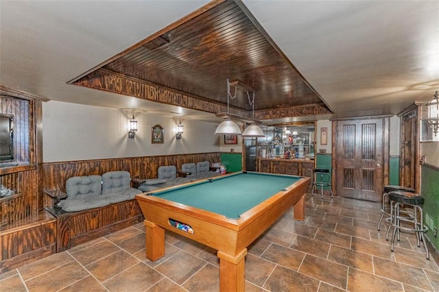 24545 W 54th St, Shawnee, KS 66226 - game room featuring bar area, billiards table, wainscoting, wooden walls, and a tray ceiling