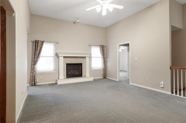 unfurnished living room featuring carpet floors, ceiling fan, and baseboards