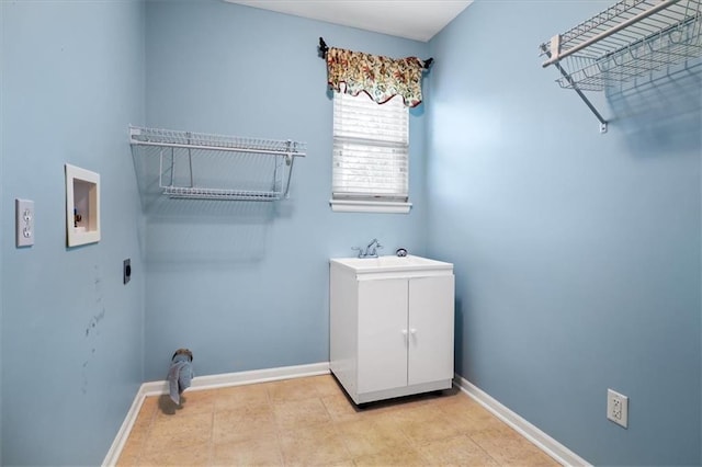 laundry room with cabinet space, washer hookup, a sink, baseboards, and hookup for an electric dryer