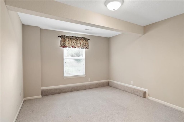 empty room with baseboards and carpet