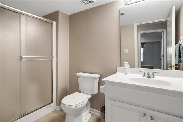 bathroom with vanity, toilet, baseboards, a shower stall, and visible vents