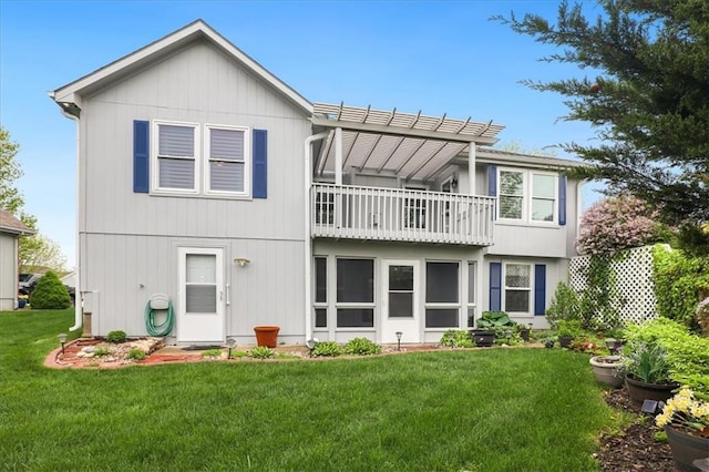 rear view of house with a pergola, a yard, and a balcony