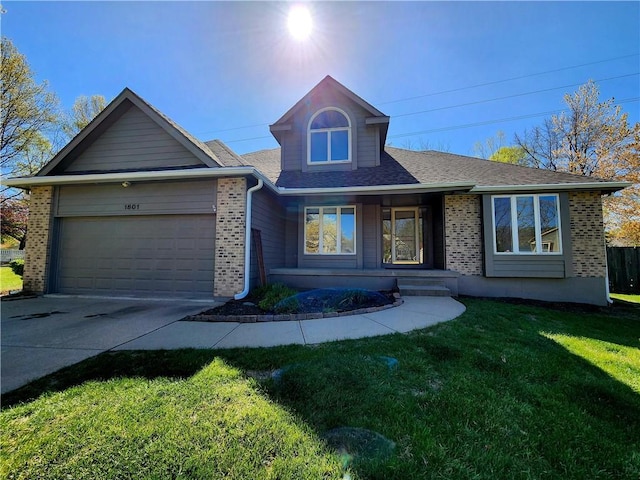 view of front facade featuring brick siding, driveway, an attached garage, and a front lawn