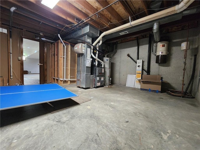 unfinished below grade area featuring gas water heater and heating unit