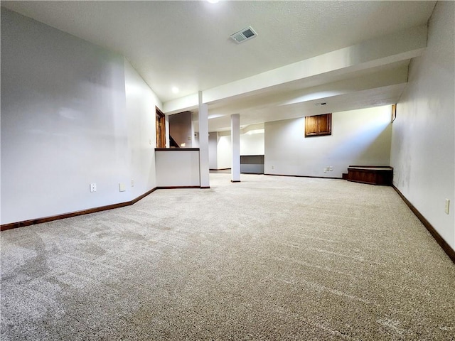 interior space with visible vents, baseboards, and carpet flooring