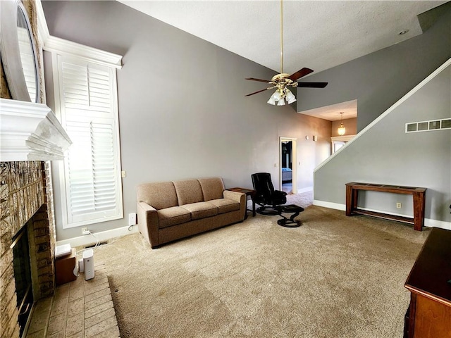 living room featuring baseboards, a fireplace, a ceiling fan, visible vents, and carpet