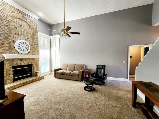 carpeted living room featuring baseboards, a textured ceiling, a ceiling fan, a brick fireplace, and high vaulted ceiling