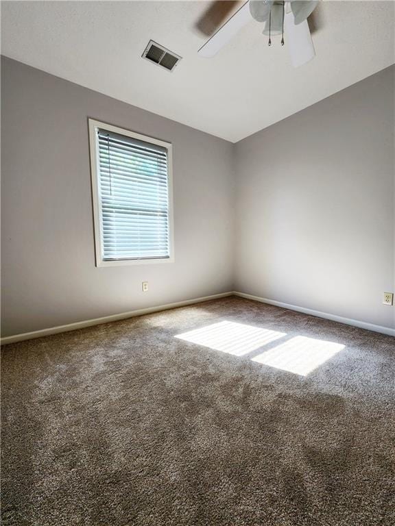 unfurnished room featuring ceiling fan, baseboards, visible vents, and carpet floors