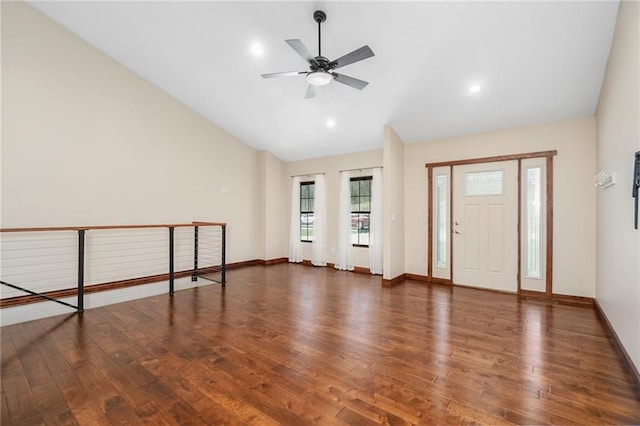 entryway featuring baseboards, vaulted ceiling, wood finished floors, and ceiling fan