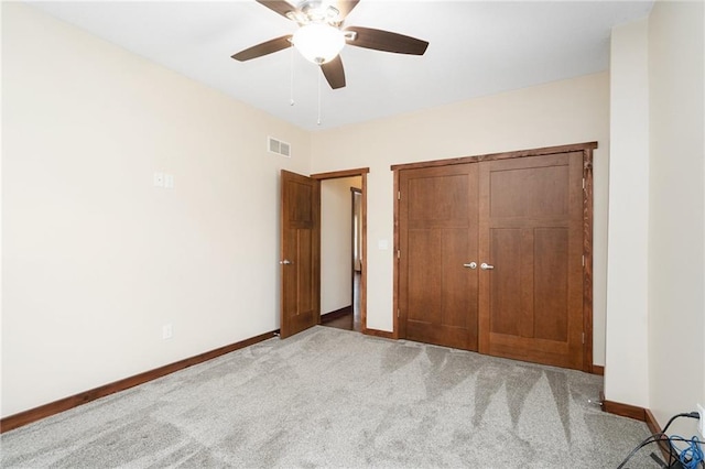 unfurnished bedroom featuring a closet, visible vents, carpet flooring, and baseboards
