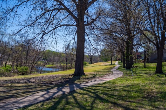 surrounding community with a lawn and a water view