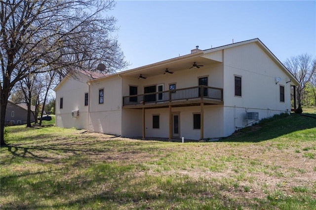 back of property featuring a wooden deck, a yard, and ceiling fan