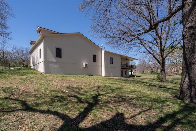 view of side of home with a yard