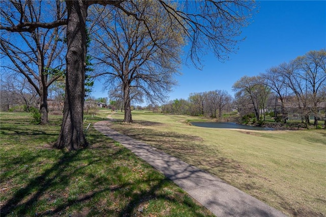 view of community with a lawn and a water view
