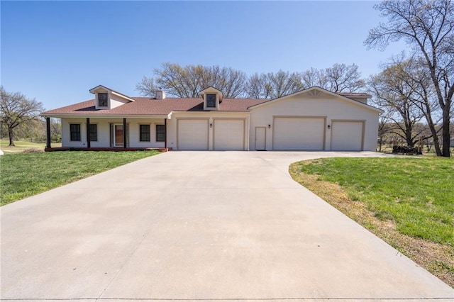view of front facade featuring concrete driveway, a front lawn, and a garage
