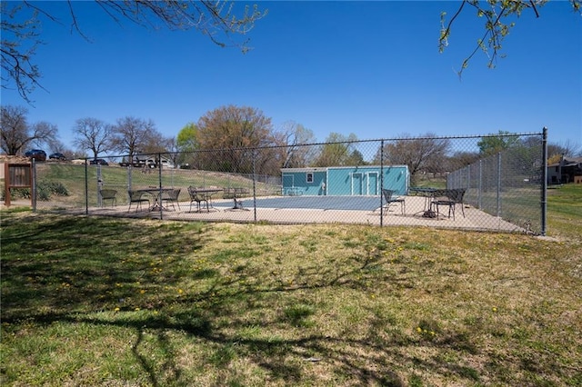 view of pool with a yard and fence