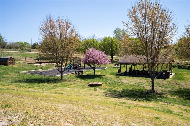 view of home's community featuring a gazebo, a storage unit, and a lawn