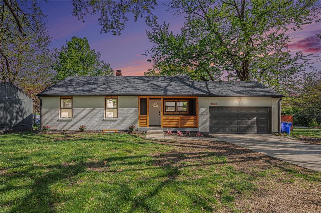 6700 W 65th Ter, Overland Park, KS 66202 - single story home featuring a lawn, an attached garage, driveway, and a chimney